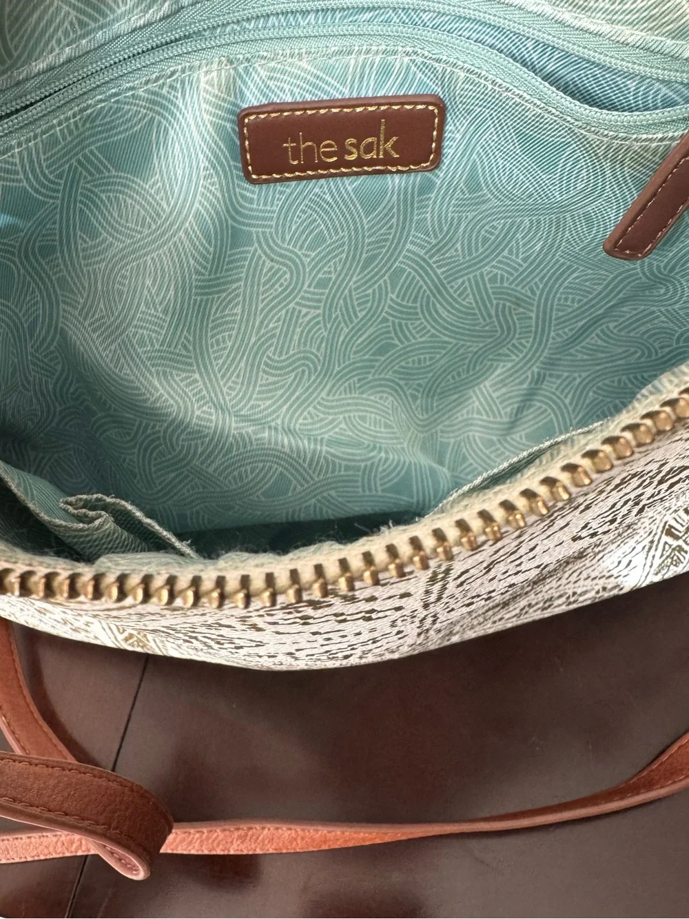 the Sak - Cream and Gold Crossbody Bag with Geometric Pattern